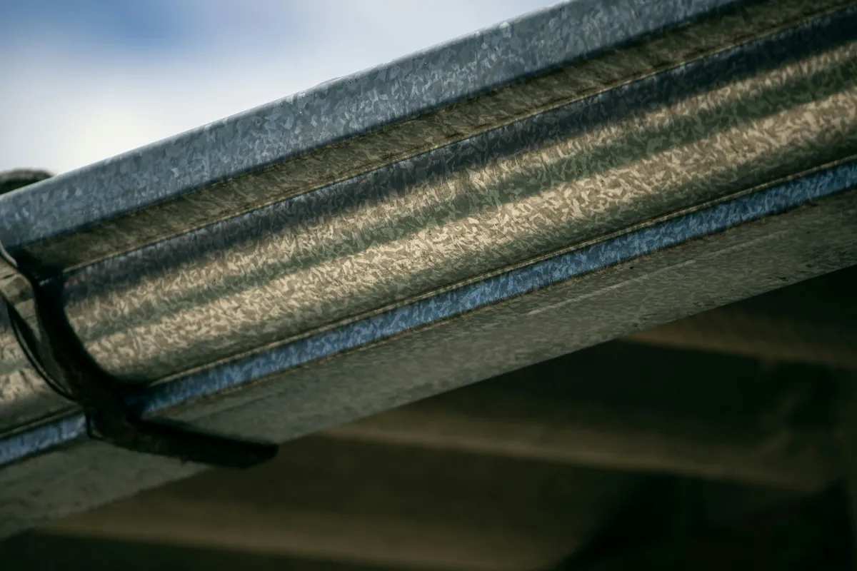 Close-up of a metal gutter along a roof edge